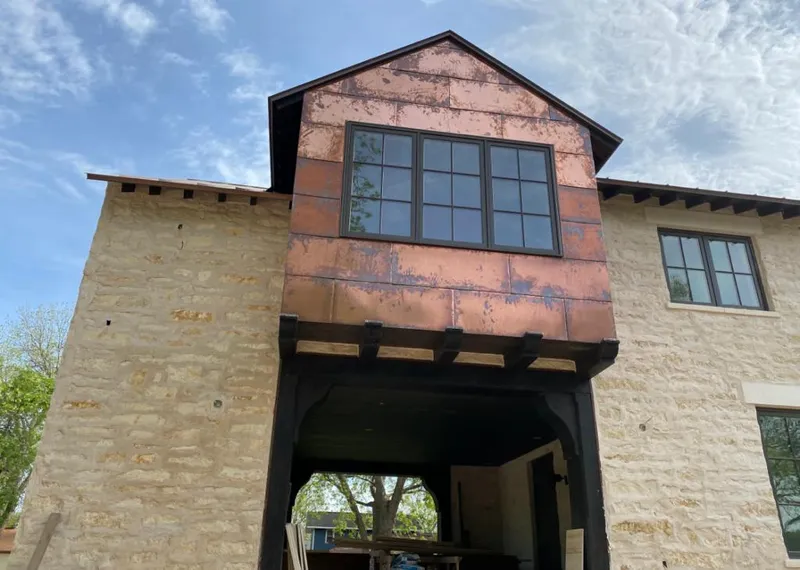 Copper metal panel facade on a stone building for Skylight Installation in Attalla